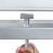A hand holding a metal bar with a metal ring on the end.