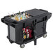 A black Cambro Versa Ultra work table with bottles on a black cart.