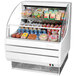 A white Turbo Air low profile air curtain display case with food inside.