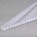 A clear plastic triangle shaped pie server with a plastic handle.