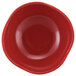 A close-up of a red bowl with a white background.