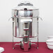 A Vollrath stainless steel soup marmite with stainless steel accents.