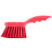 A red Carlisle Sparta pot scrub brush with a handle.