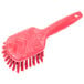 A red Carlisle Sparta utility and pot scrub brush with a handle.