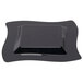 A close-up of a black plastic square plate with a wave pattern.