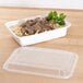 A white Pactiv rectangular microwavable container with noodles and meat in it.