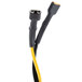 A close-up of a black and yellow cable with a black connector.