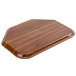 A Cambro Burma Teak fiberglass tray on a wooden surface.