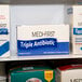 A white box of Medique Medi-First Triple Antibiotic Ointment packets.