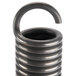 A close-up of a 1" x 6 1/2" metal door spring coil.