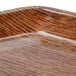 A close up of a Cambro Country Oak fiberglass tray with a brown wood finish.