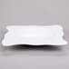 A white square melamine bowl with a wavy design.