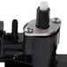 A close up of a black Cornelius syrup valve assembly with a white valve.