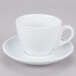 A close up of a CAC white cup and saucer with a white handle.