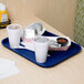 A cobalt blue GET fast food tray with food and a drink on a table.