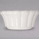 A white bowl with a scalloped edge.