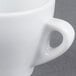 A close up of a white CAC E-3 Venice espresso cup with a saucer.