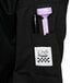 A person wearing a black Chef Revival chef coat with a pen and a purple pen in the pocket.