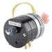 A round black and silver electric timer with yellow wires.