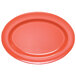 An orange oval melamine platter with a pink circle in the center.