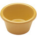 A close-up of a yellow Elite Global Solutions melamine ramekin.