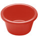A coral melamine ramekin with a white interior.