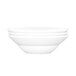 A white bowl with a stack of white bowls on top of it.