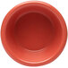 A close-up of a red Elite Global Solutions melamine ramekin.