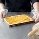 A Gobel fluted rectangle tart pan with a peach quiche in it.