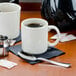 A close up of a white Homer Laughlin Shakespeare mug on a table.