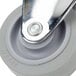 A close-up of a grey Cambro rear caster wheel with a silver knob.