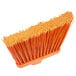 A Carlisle medium duty broom head with orange flagged bristles.