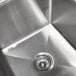 A close up of an Advance Tabco stainless steel sink with left drainboard.