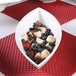 An Elite Global Solutions white melamine oval bowl filled with fruit on a table.