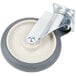 A grey and white swivel castor with a metal plate and metal wheel.