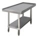 A stainless steel Advance Tabco equipment stand with a shelf.