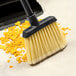 A close-up of a Carlisle medium duty broom head with flagged bristles.