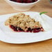 A slice of Lucky Leaf strawberry pie with whipped cream and a cherry on top.