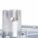 A close-up of a Robot Coupe 3/8" French fry disc, a metal cylinder with a metal ring on top.
