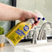 A bottle of Bar Keepers Friend 25.4 oz. all purpose spray foam cleaner being used to clean a bathroom sink.