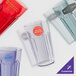 A close-up of a jade GET plastic tumbler with a drink inside.