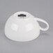 A white teacup with a handle.