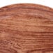 A close up of a Cambro Java teak fiberglass tray with a brown rim.