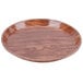 A round java teak fiberglass Cambro tray.