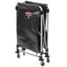 A black Rubbermaid replacement bag on a metal stand.