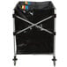 A black and silver Rubbermaid laundry cart with colorful bags inside.