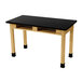 A black National Public Seating science lab table with wood legs.