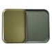 Two olive green Cambro trays, one empty and one full, on a counter.