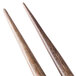 A close-up of a pair of Zeroll stainless steel deco spoons with wooden handles.