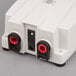 The Grindmaster-Cecilware 63174 external water pump in white packaging with red and black plugs.